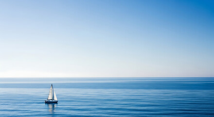 Obraz premium A lone sailboat glides across a vast, serene ocean under a clear, bright sky.