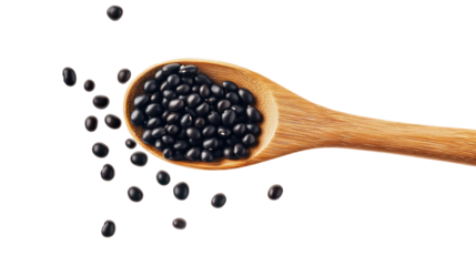 Black beans falling from wooden spoon on transparent background