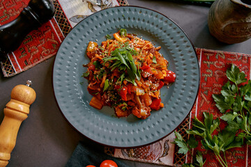 A Colorful Dish of Stir-Fried Vegetables and Chicken Garnished with Fresh Herbs and Sesame Seeds on a Decorative Plate