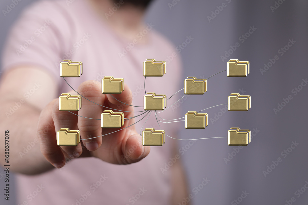 Aufkleber hand interacts with a network of digital folders, illustrating data management and connectivity.