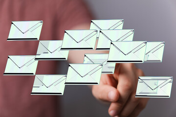 Person interacting with digital emails, inbox management, digital communication.