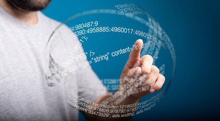 Person touching a holographic sphere filled with digital data and code.