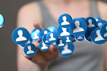 Abstract image of a hand reaching for a network of blue profile icons.  Ideal for social media,...