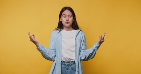 young woman sits calmly in a meditative pose, eyes closed, exuding a sense of peace and tranquility on vibrant yellow background