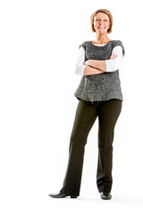Fototapeta premium Confident businesswoman with arms crossed. A smiling woman in smart-casual business attire stands confidently with her arms crossed against a white background.
