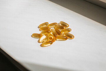 Omega-3 in sunlight. Natural fish oil for hair growth. The concept of vitamins and dietary supplements
