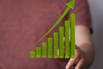 Stock photo of upward trending bar graph, symbolizing financial success and business growth.