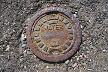 water manhole cover on the road