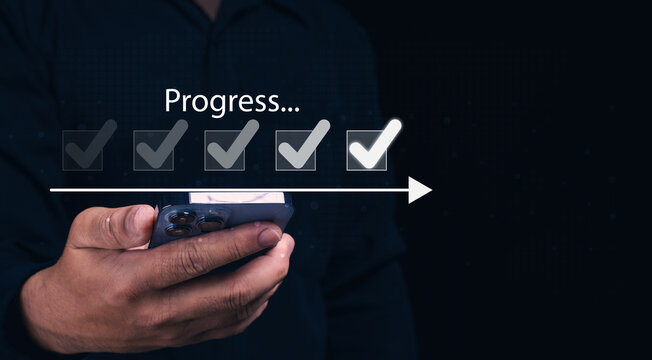 A hand holding a smartphone displays a progress indicator with checked boxes, symbolizing task completion and advancement.