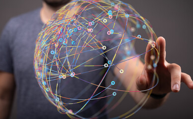 Abstract image of a man interacting with a digital sphere representing global network connections.