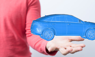 A hand holds a digital rendering of a modern blue car, symbolizing innovation and technology in the...