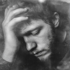 Random photo effect of a young man in depression, reflecting on his mental problems and looking for a way to cope with stress. Expressive emotions.