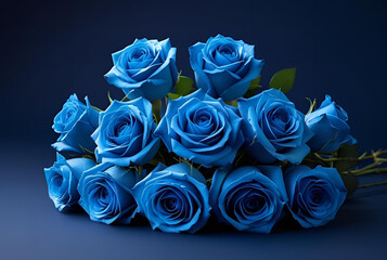 Bouquet of blue roses lying on a dark blue surface