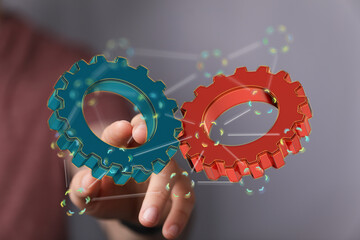 Image of two gears meshing, symbolizing teamwork, collaboration, and synergy in business.