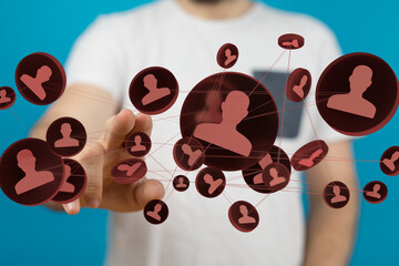 Hand interacting with a digital network of interconnected people, representing social media,...