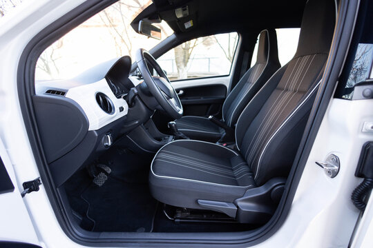 Steering wheel of a electric vehicle, interior, electric buttons, digital speedometer, front seats, textile, windows, console, gear shift. Car dashboard with a digital touchscreen