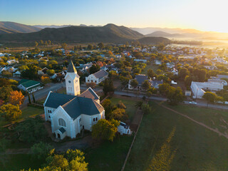 Aerial over small town with church at sunrise, Mcgregor, South Africa
