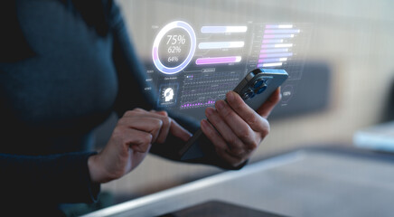 A person interacts with a smartphone displaying digital analytics, showcasing data insights and user engagement metrics in a modern tech environment.