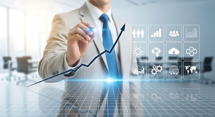 Businessman draws upward trending graph with business icons displayed on a digital interface
