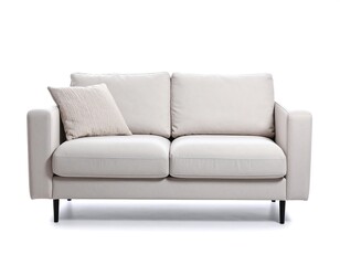 Fototapeta premium Cream colored couch against white background