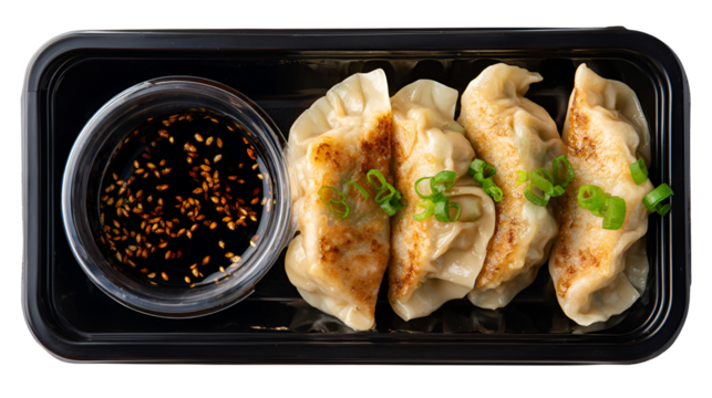 Delicious momos served on a white plate with a savory sauce. background removed