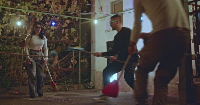 Friends having fun at a backyard party, playing games and enjoying the night together.