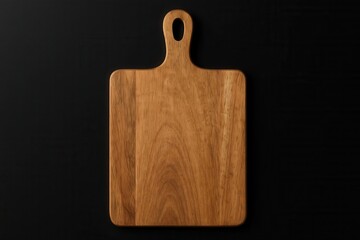Fototapeta premium A wooden cutting board with a handle on a black background