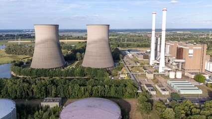 Aerial view of power plant with cooling towers and chimneys.