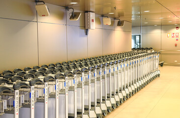 Row of airport trolleys get ready to serve passengers at Airport terminal.