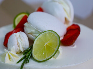 A cake decorated with fresh fruits and desserts, creating a festive and appetizing look. The...