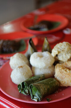 Various traditional snacks on red plate. 