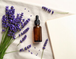 Lavender flowers and dropper bottle on soft towel with notebook