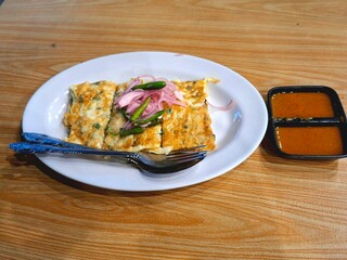 Delicious egg martabak, complete with sauce and chili sauce