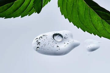 A drop of natural cosmetics with a mint leaf.