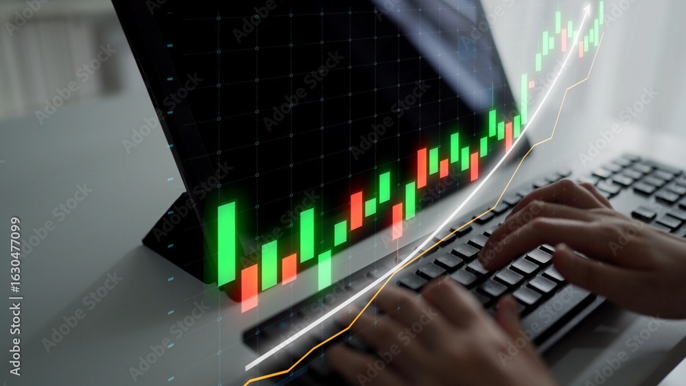 Poster hands typing on a keyboard in front of a screen displaying a stock market graph. the image captures 