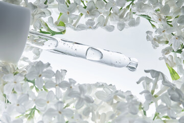 A serum pipette with white flowers.