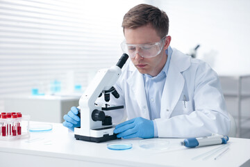 Medical analysis. Scientist working with microscope in laboratory