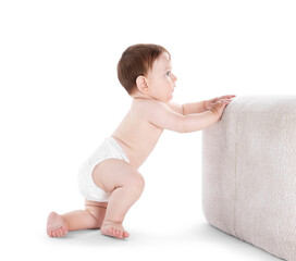 First steps. Cute little baby in diaper near pouf on white background