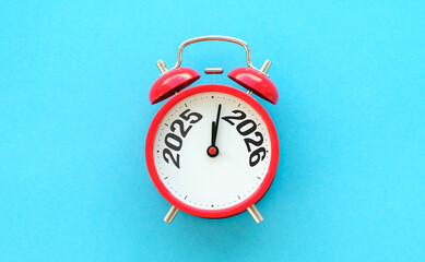 Happy New Year with red alarm clock and 2025 change to 2026 number. Merry Christmas, New Start,...