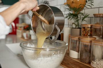 female hands preparing dough in the kitchen