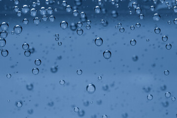 Soda water with bubbles of gas in glass, closeup