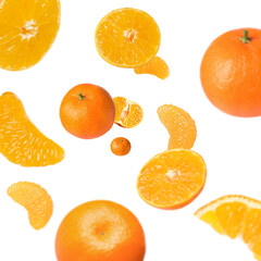 Sweet tangerines whirling in air against white background
