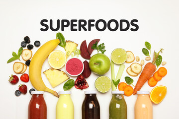 Superfoods. Healthy smoothies in glass bottles and ingredients on white table, top view