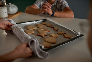 female hands holding a tray with fresh homemade gingerbread