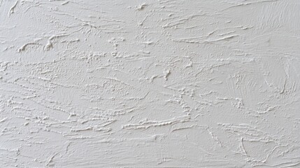 Smooth white wall with subtle texture imperfections, minimalistic and clean surface under even lighting.
