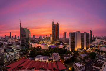 Modern buildings in the city with water reflection, firework, light show at twilight time.