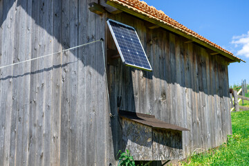 View of a small solar panel installed on a rural barn of a small farm, producing electricity....