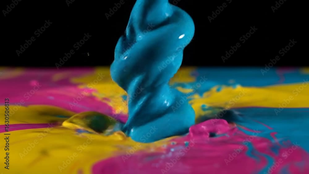 Poster close up of vivid paint splashes in yellow blue and pink tones with dynamic fluid motion on a black 