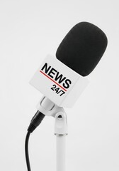Microphone with News 24/7 sign on white background