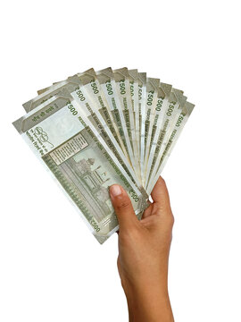 Hand holding multiple 500 rupee indian currency notes fanned out isolated on transparent background. Finance, cash payment, salary, investment, and banking concepts.